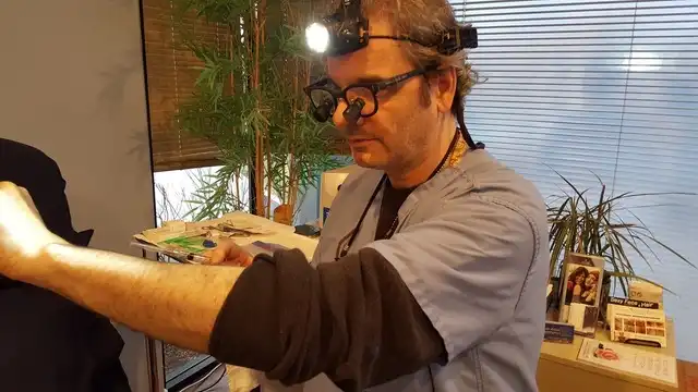 Thomas Pulice PA-C performing aesthetic treatment with surgical loupes and headlamp at Las Vegas Aesthetics — precision and clinical expertise, Las Vegas NV